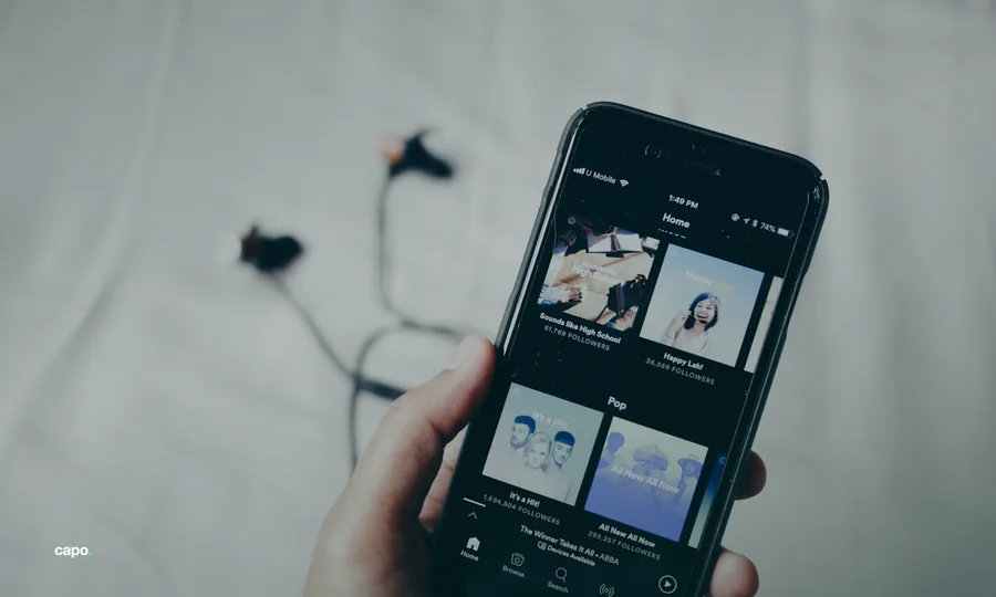 a phone playing music, held in one hand